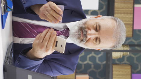 Vertical-video-of-Old-businessman-shopping-on-the-phone.